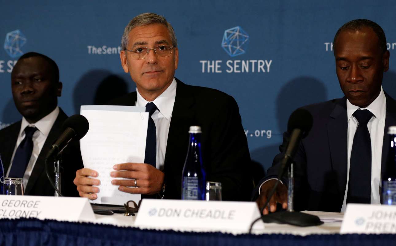 George Clooney, with fellow actor Don Cheadle and The Sentry investigative journalist Brian Adeba (Reuters: Jonathan Ernst)